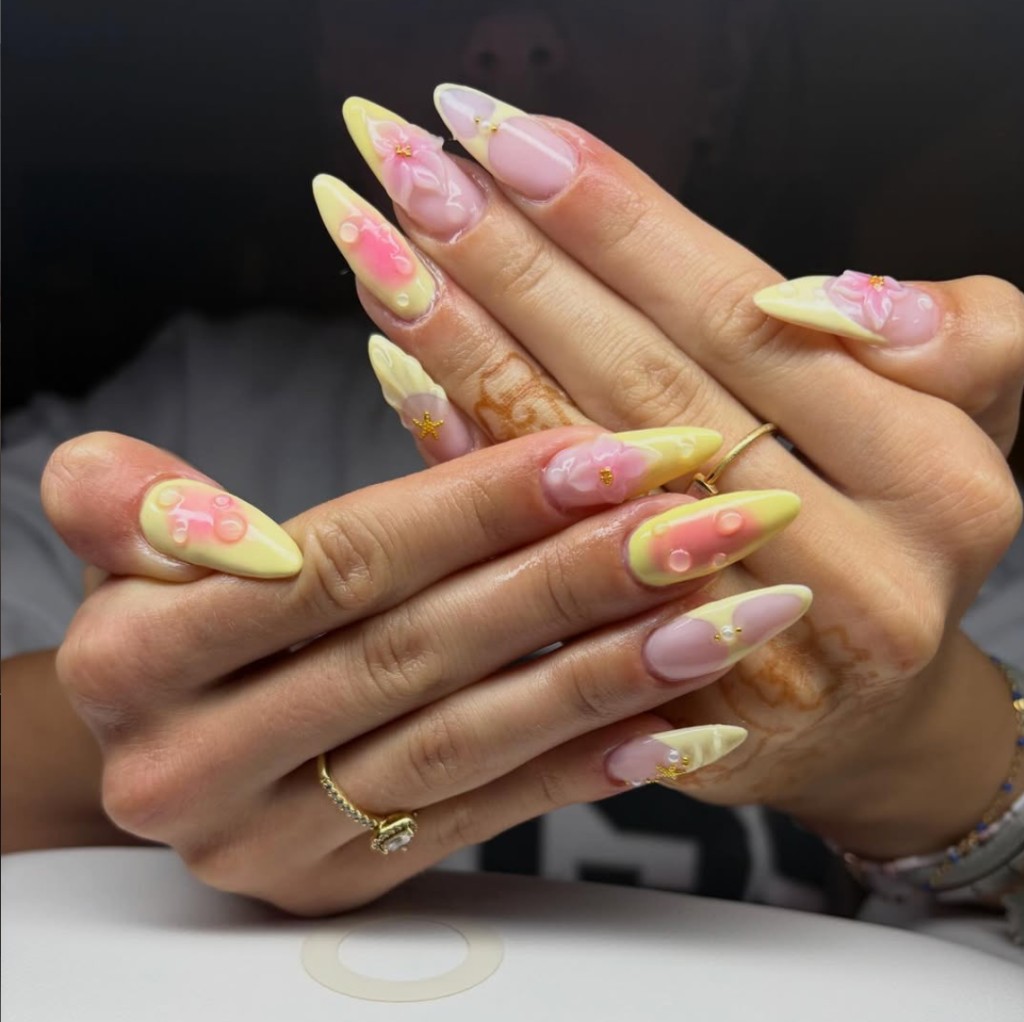 3D floral nail art with gold accents and detailed gel work