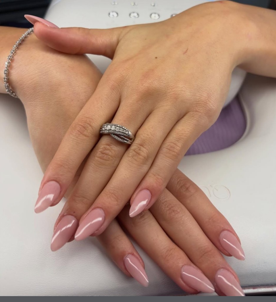 Glossy nude pink gel manicure with almond-shaped nails