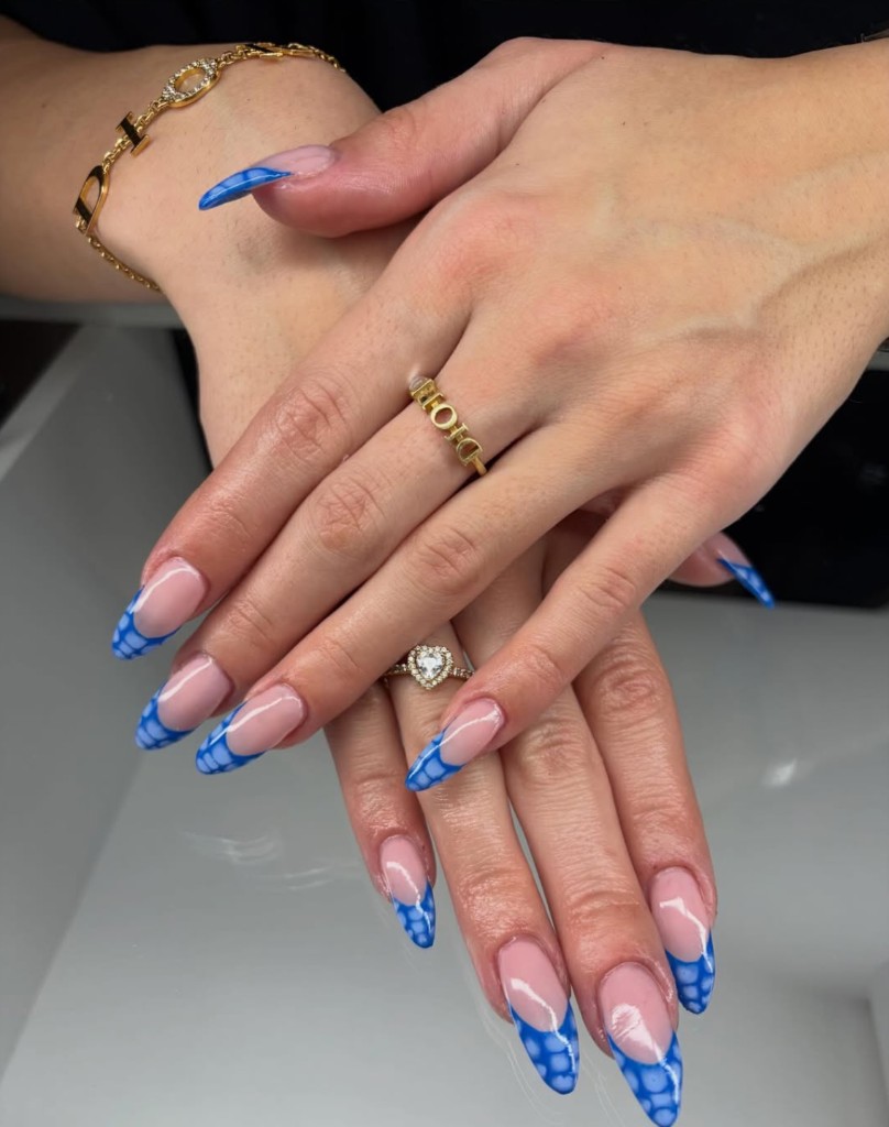 Custom blue crocodile-print French manicure with almond nails