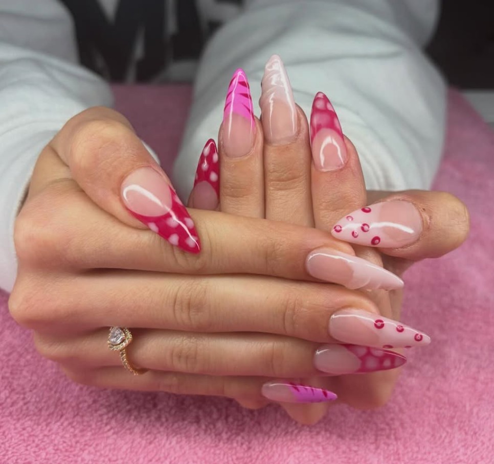 Party nails with pink nail art and stiletto shapes