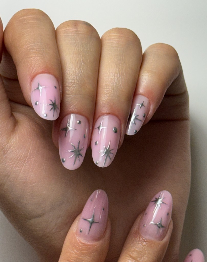 Seasonal pink gel manicure with silver star nail art
